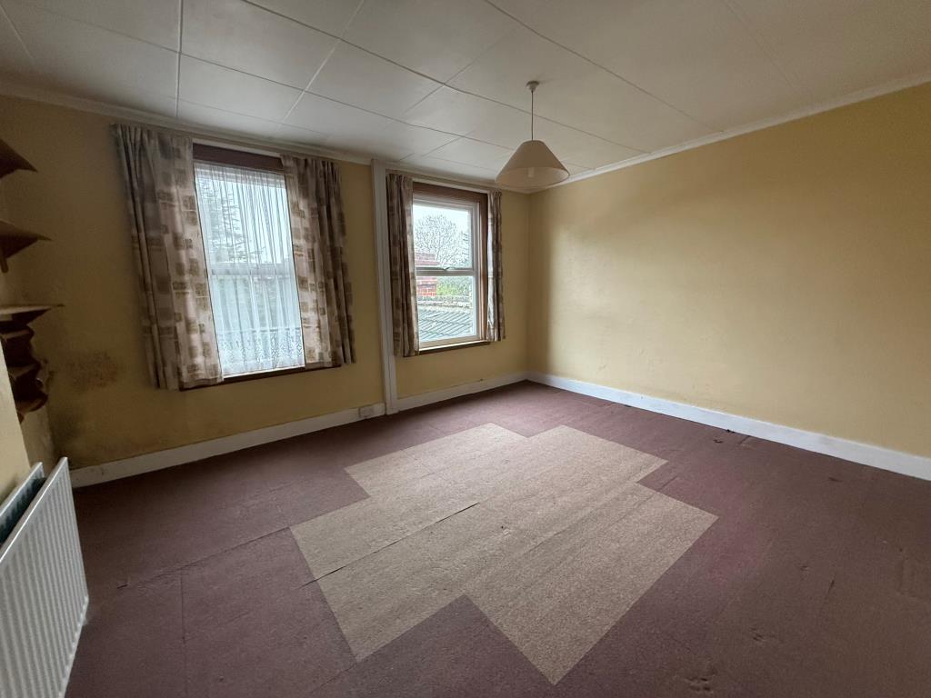 Bedroom with two windows with views of garden