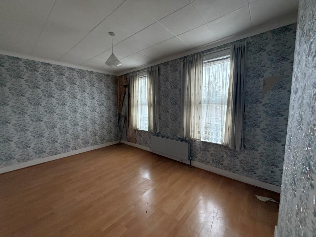 Wallpapered bedroom with two windows