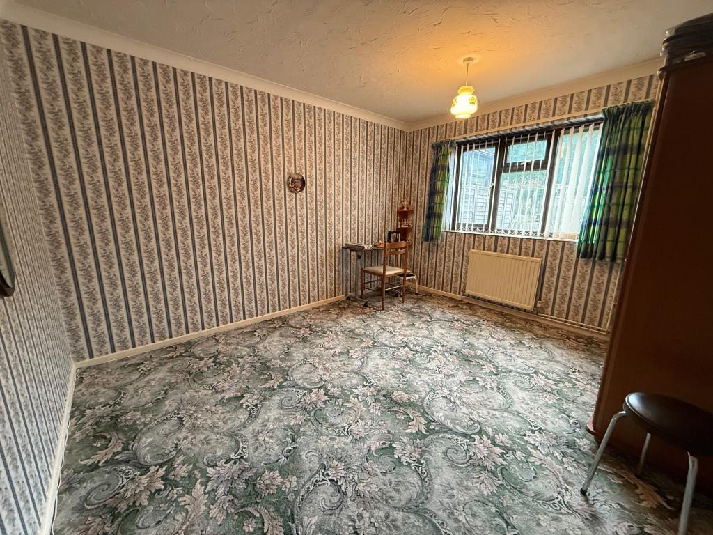Carpeted bedroom with window and wardrobe