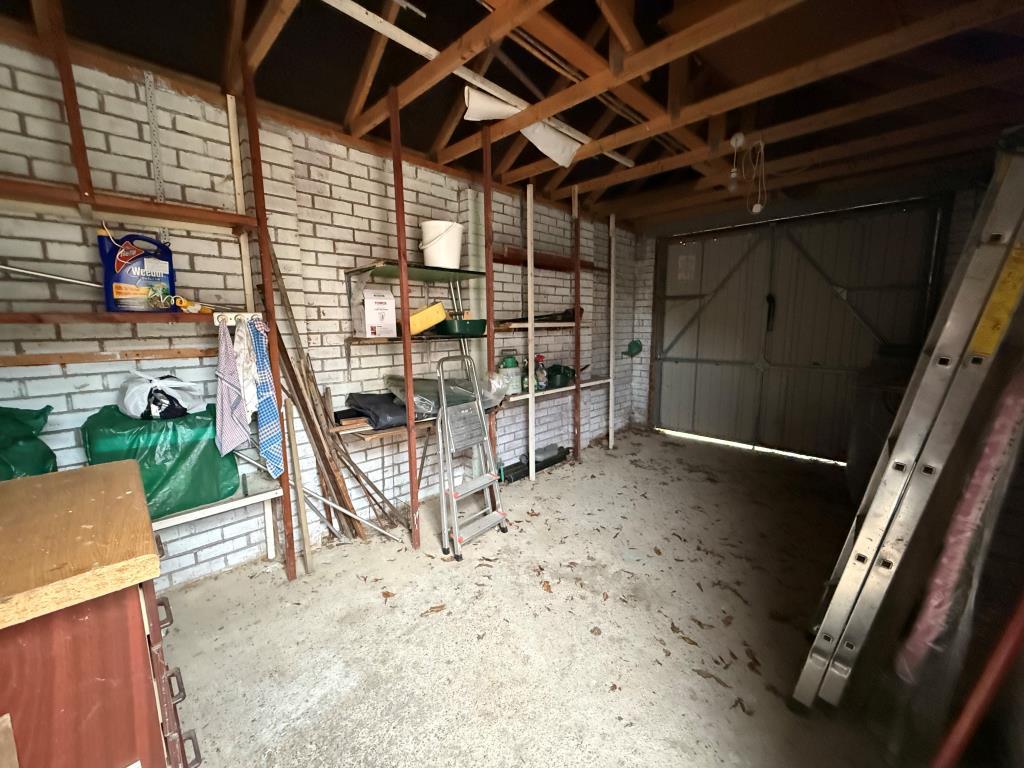 Garage with electric and shelving available