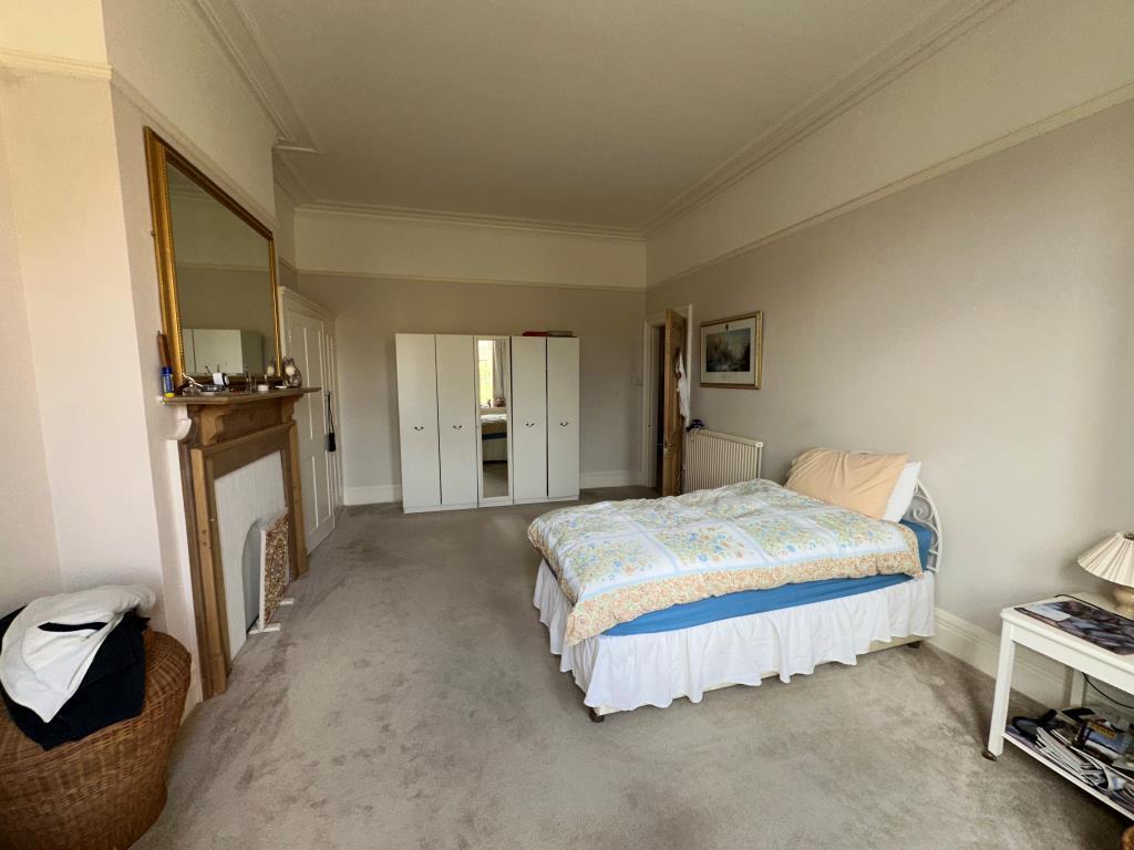 Main bedroom with built in storage and fireplace