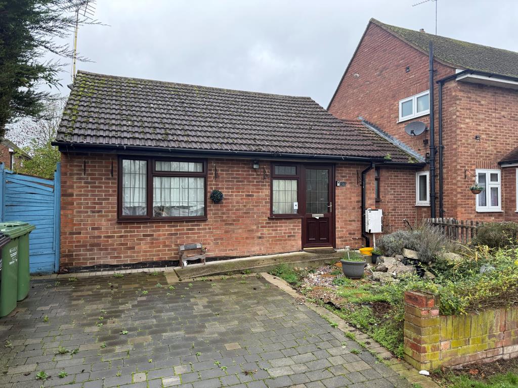 Front elevation showing driveway and front garden