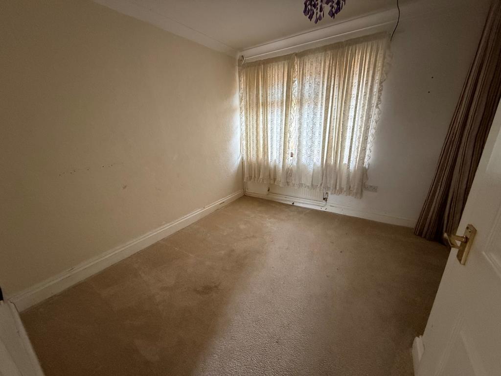 Main bedroom with window and wardrobe space