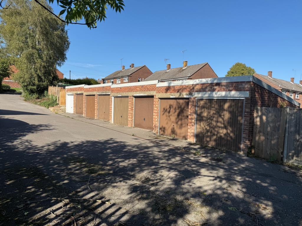 Block of eight garages looking up the hill
