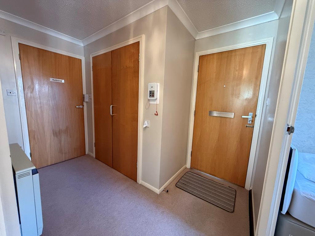 Hallway showing storage cupboard