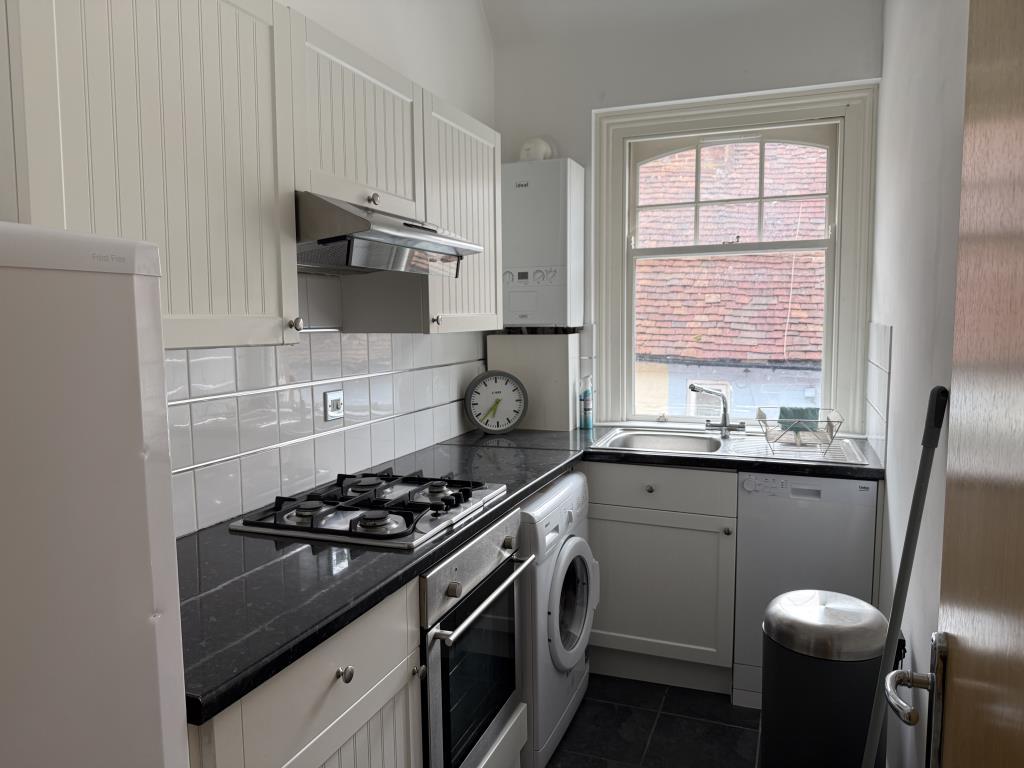 Modern fitted kitchen with goods