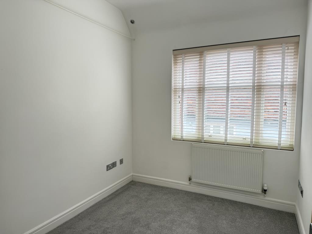 Bedroom with white walls and grey carpet