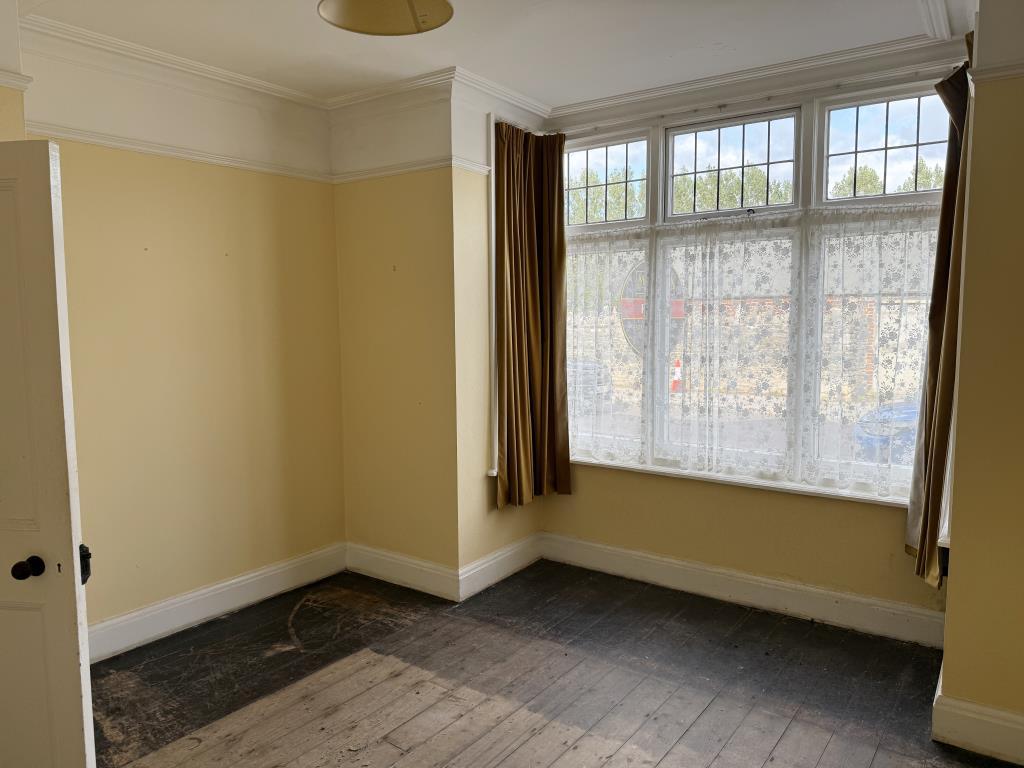Living room with painted walls and bare flooring