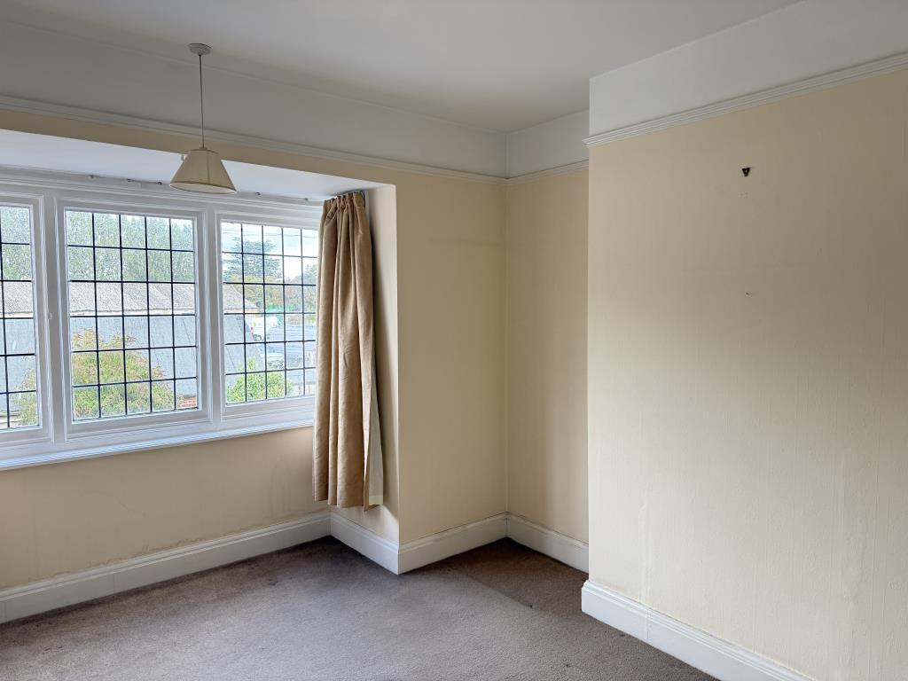 Bedroom one with magnolia walls and beige carpet