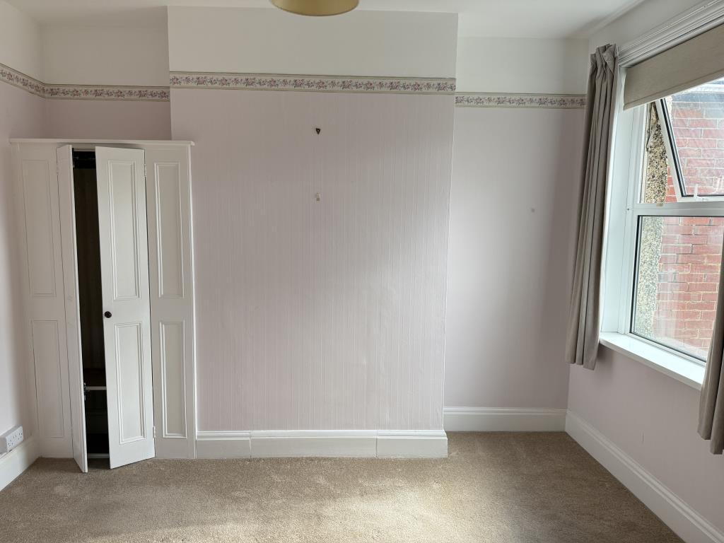 Bedroom two with fitted carpet and wallpaper