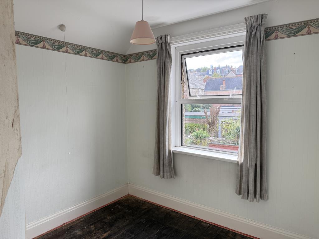 Bedroom three with bare flooring