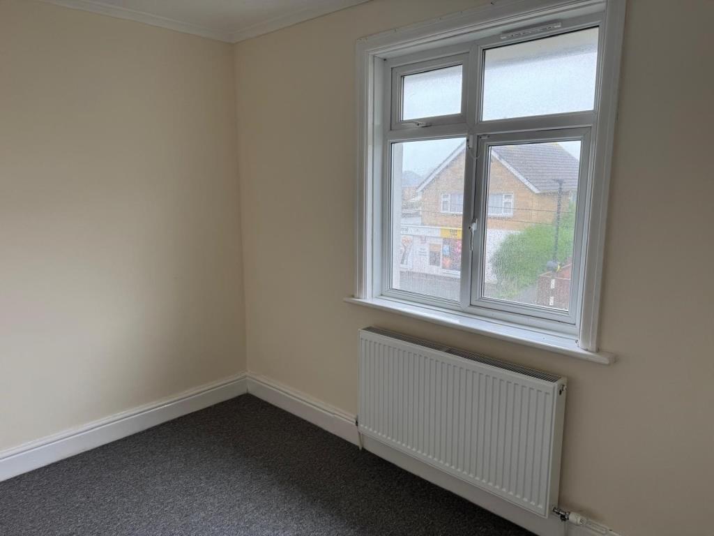 Second bedroom with carpet and magnolia wall