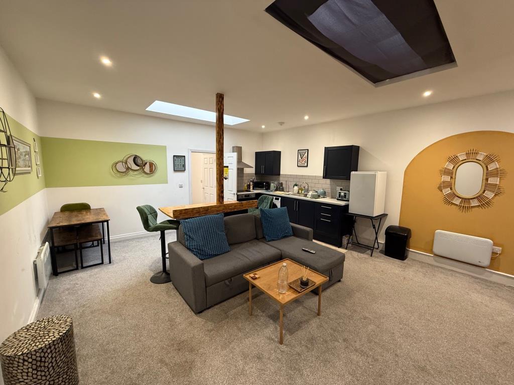 Living room with kitchen in the background