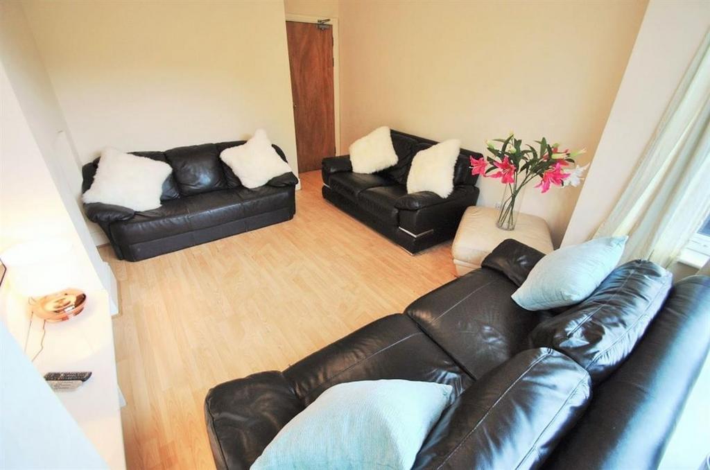 Bright, tidy living room with comfortable black...