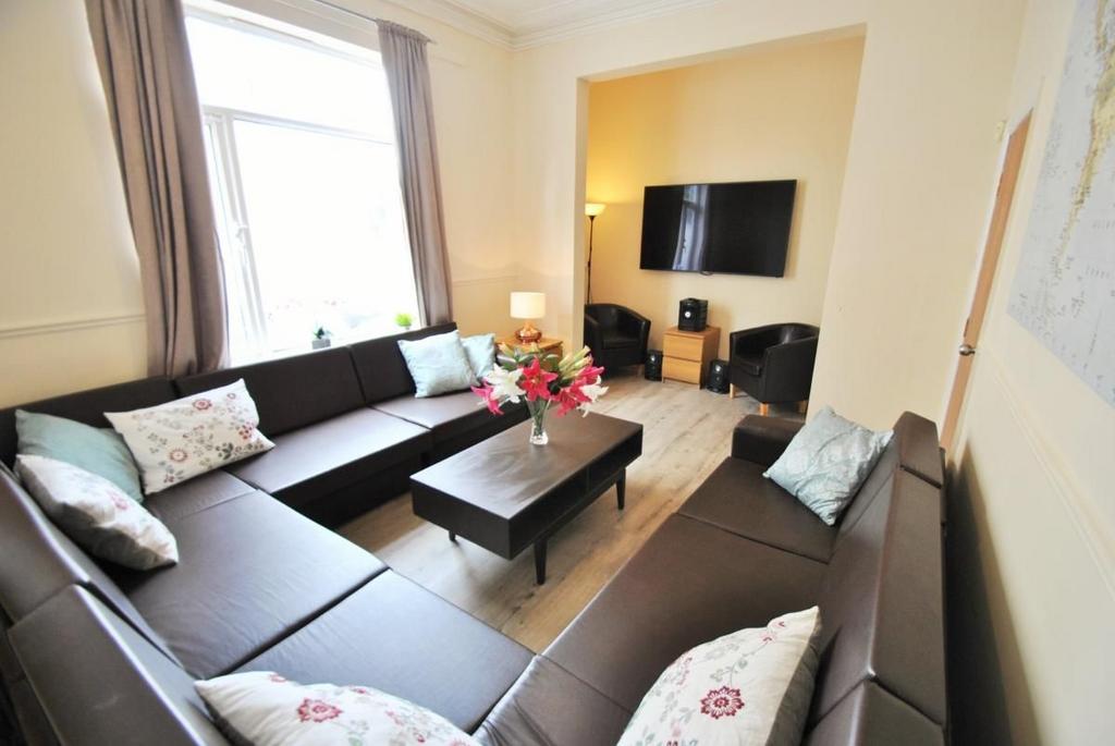 Bright communal lounge with ample seating arran...