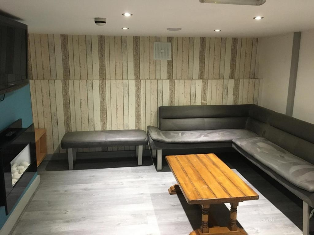 Contemporary lounge with wrap-around grey seati...