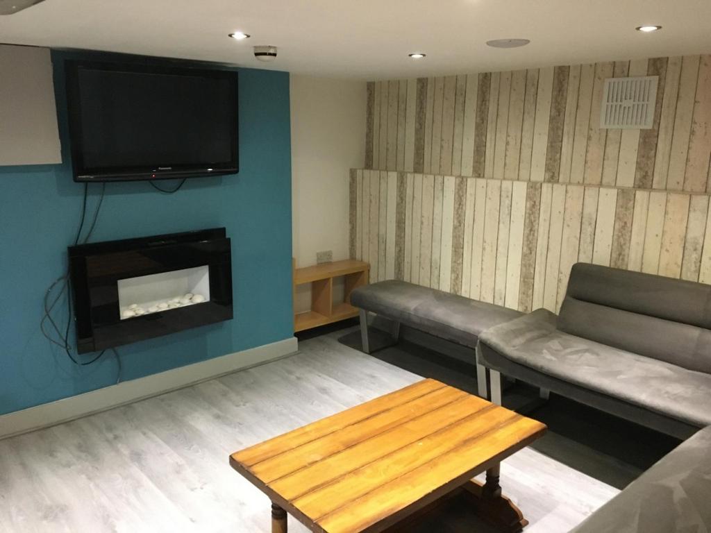 Comfortable communal lounge with modern wall-mo...