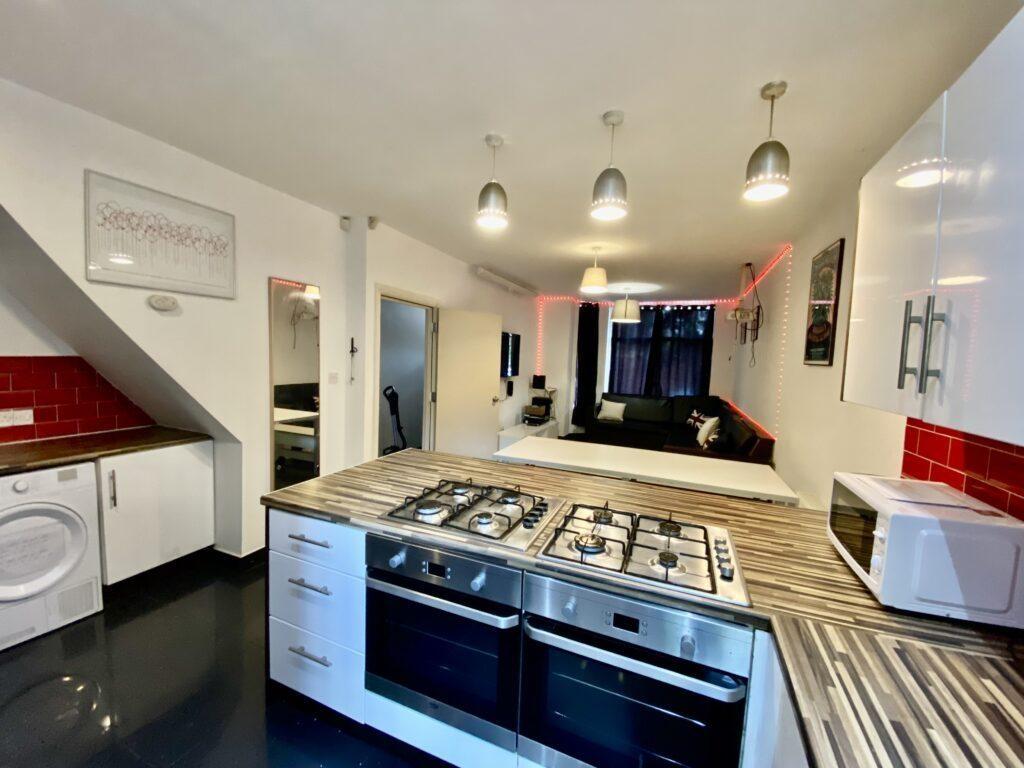 Modern open-plan kitchen with integrated gas ho...