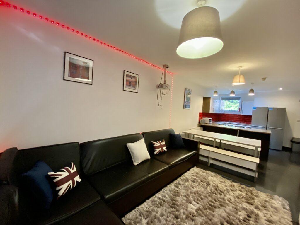 Modern open-plan living area with a black leath...