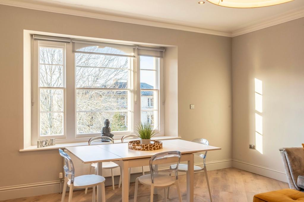 Bright, modern dining area with a large bay win...