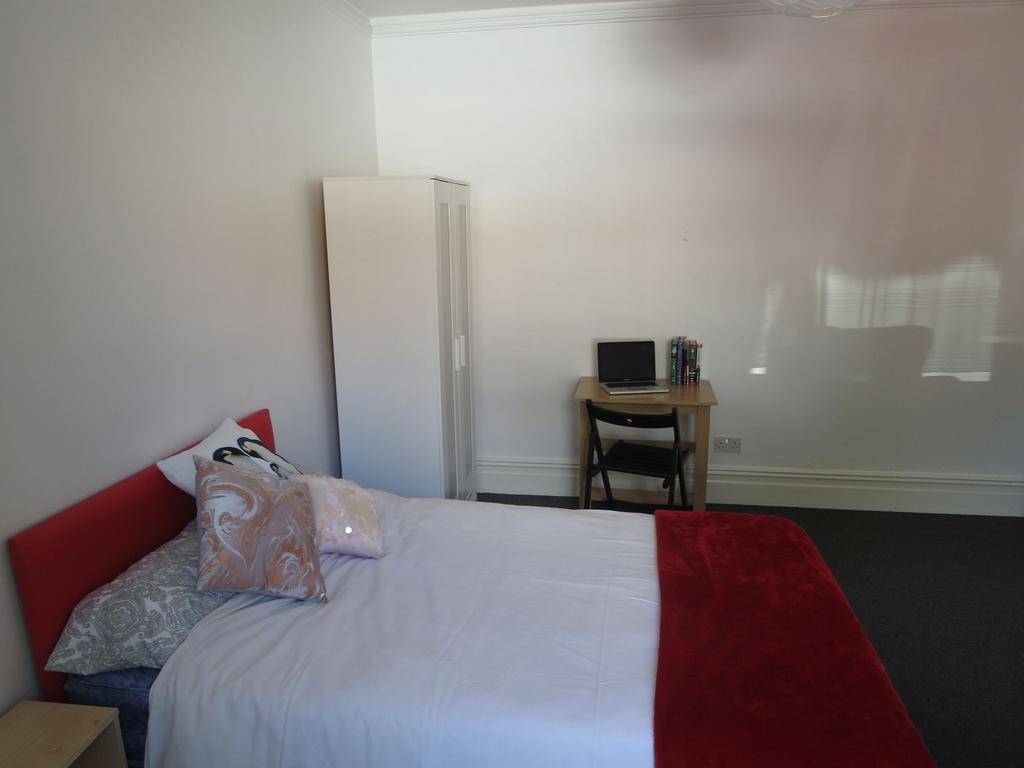 Bright, simply furnished double bedroom with a ...