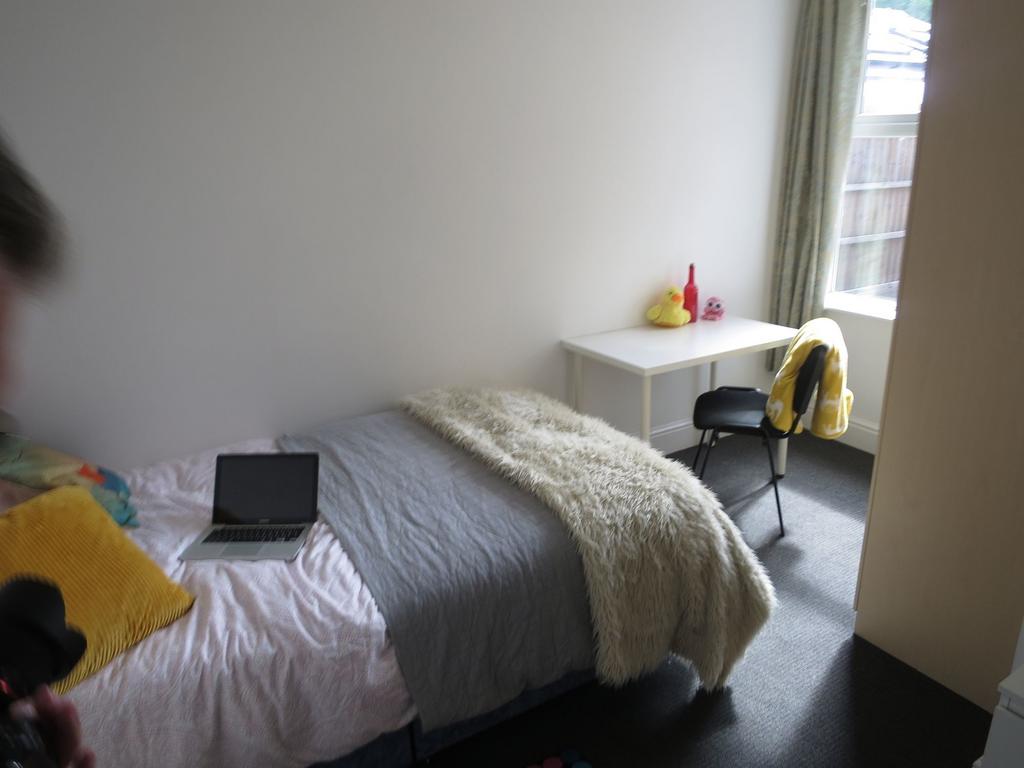 Bright, simply furnished single bedroom with a ...