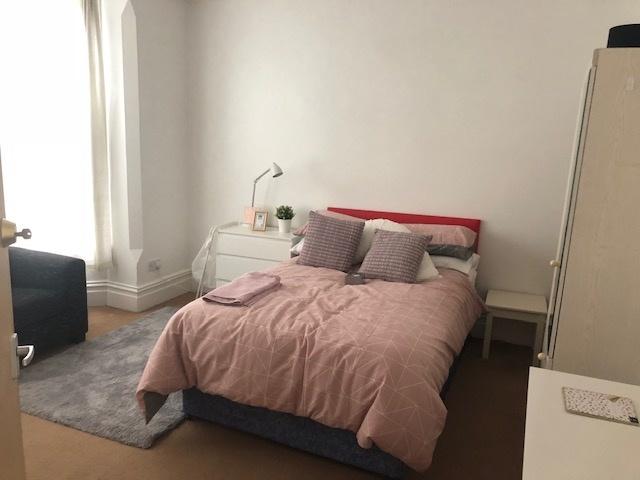 Bright, neatly presented bedroom with a comfort...