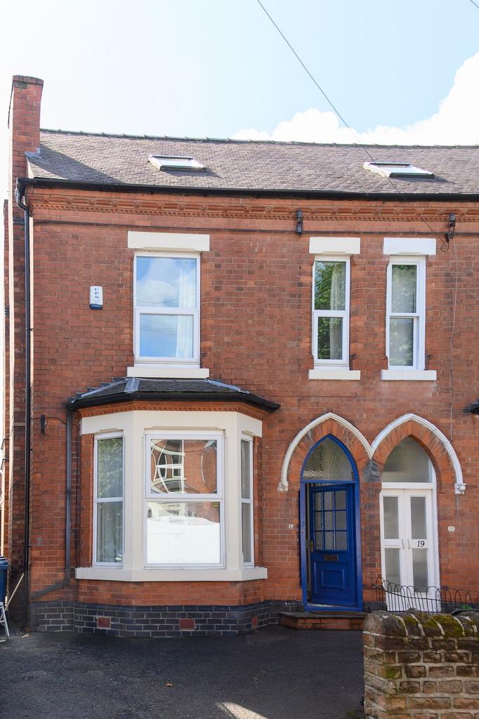 Red-brick terraced house with a distinctive blu...