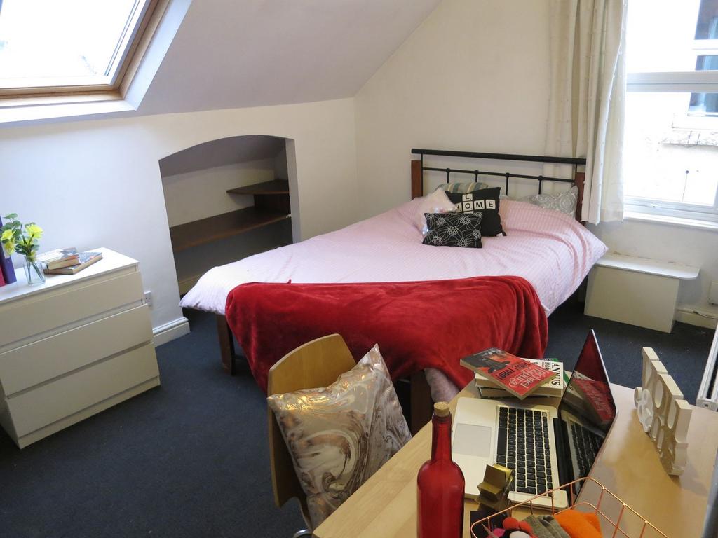 Bright, cozy attic double bedroom with a sloped...