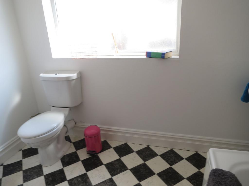 Bright, simple bathroom with classic black-and-...