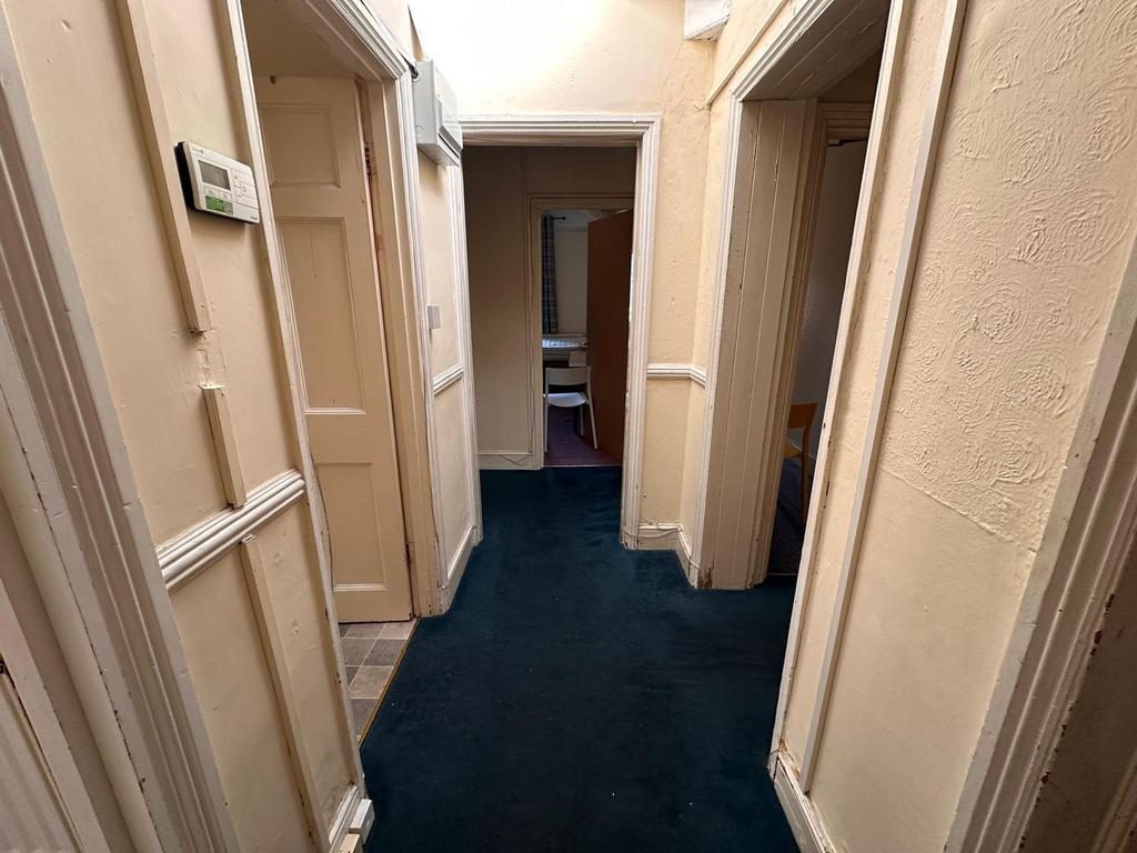 Bright internal hallway with contrasting dark c...