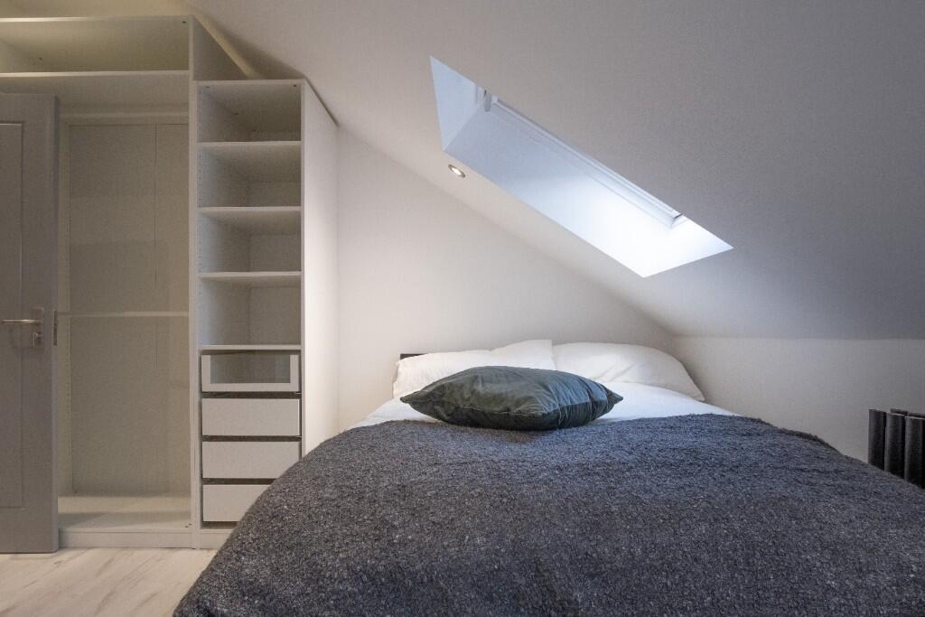 A bright and spacious master bedroom featuring ...