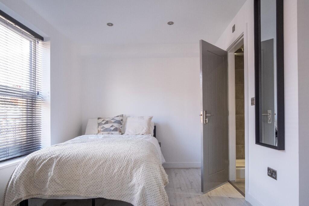 A bright and spacious master bedroom featuring ...