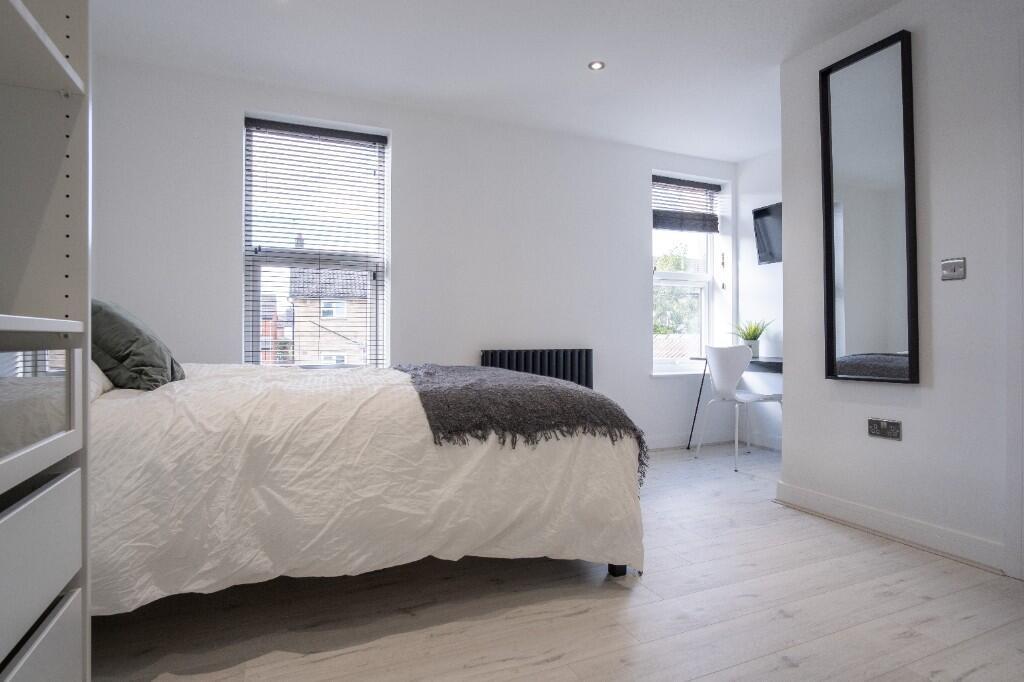 A bright and spacious master bedroom featuring ...