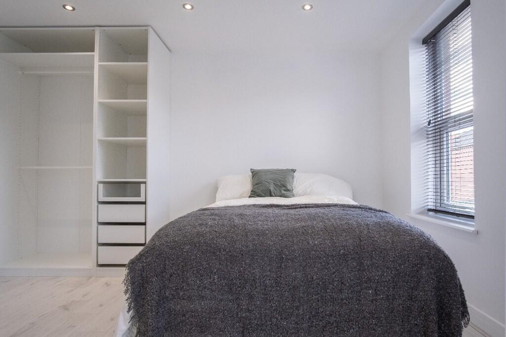 A bright and inviting double bedroom featuring ...