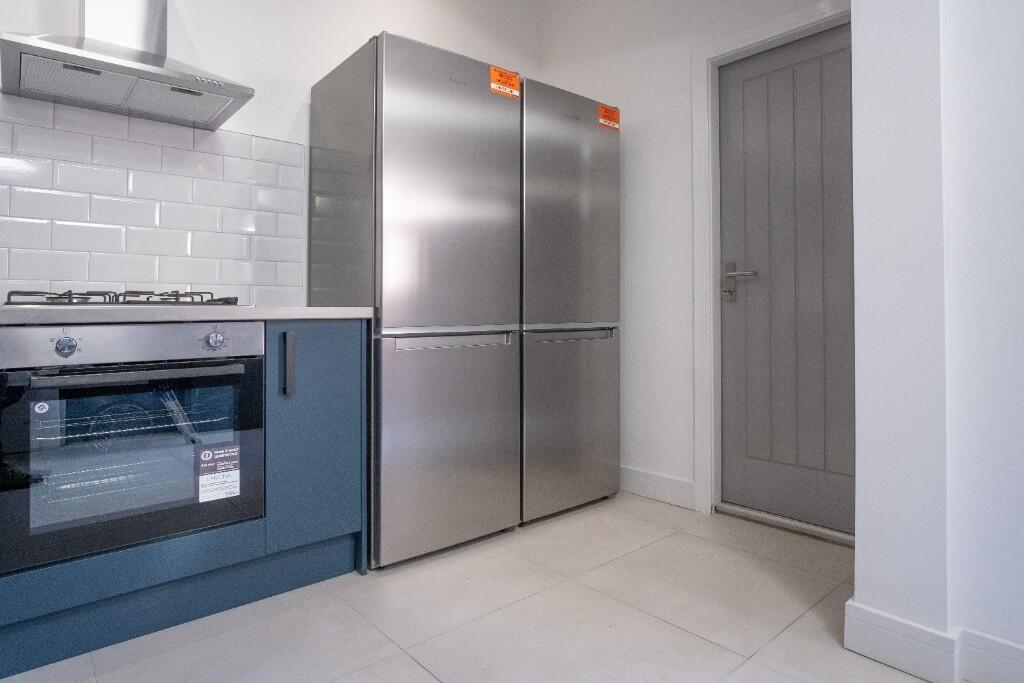 Contemporary kitchen with stainless-steel doubl...
