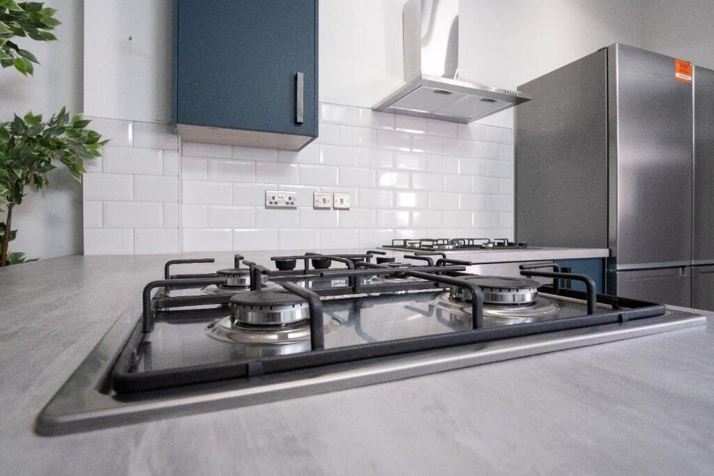 Modern kitchen with clean surfaces, stainless s...
