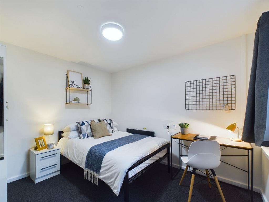 A bright and inviting double bedroom featuring ...