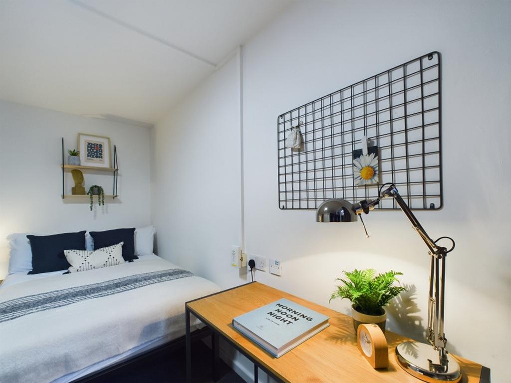A bright and inviting double bedroom featuring ...