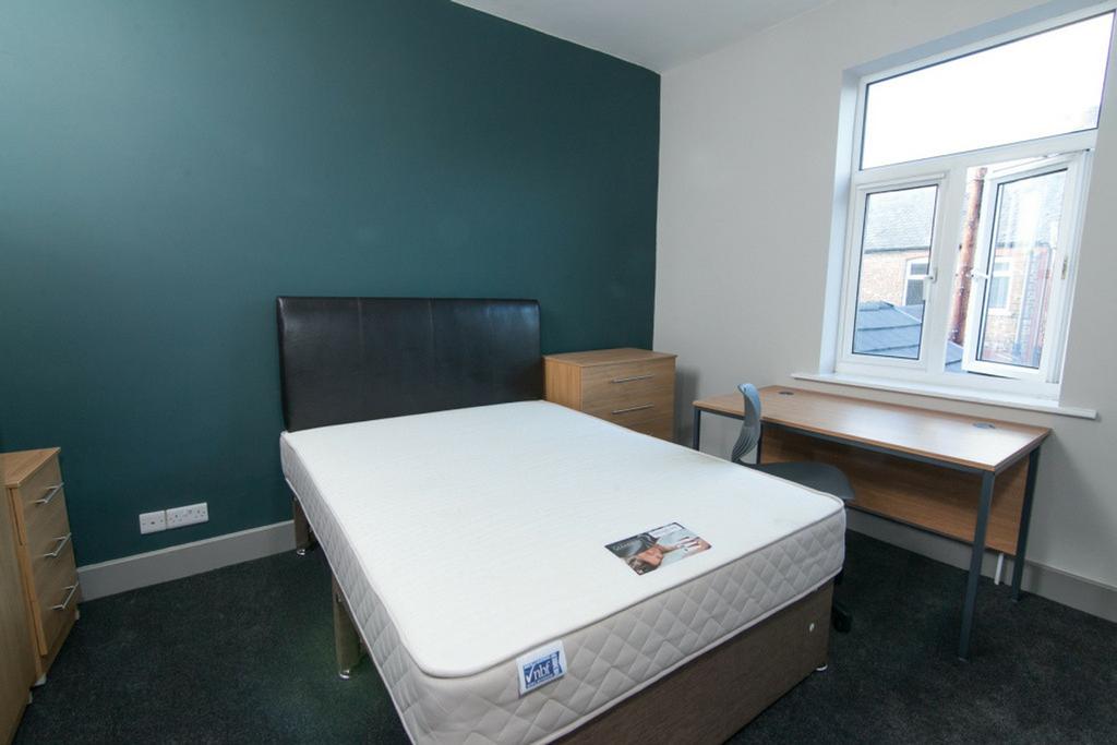 A well-lit double bedroom featuring a cozy atmo...