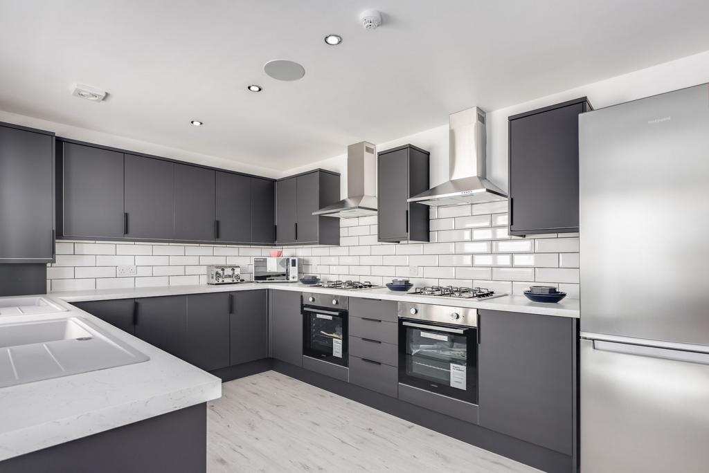 Modern and stylish kitchen featuring sleek dark...