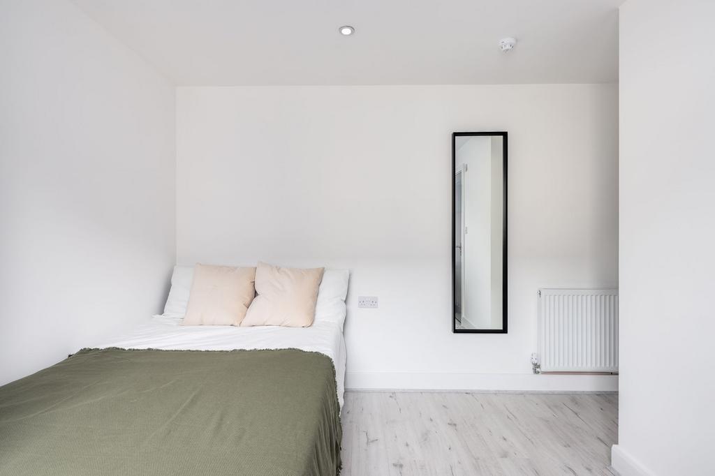 A bright and airy double bedroom with a clean, ...