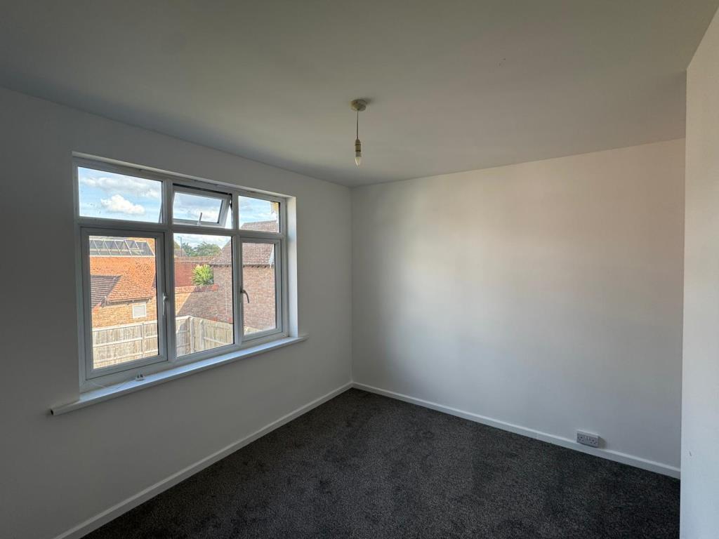 Bedroom with white walls and grey carpet