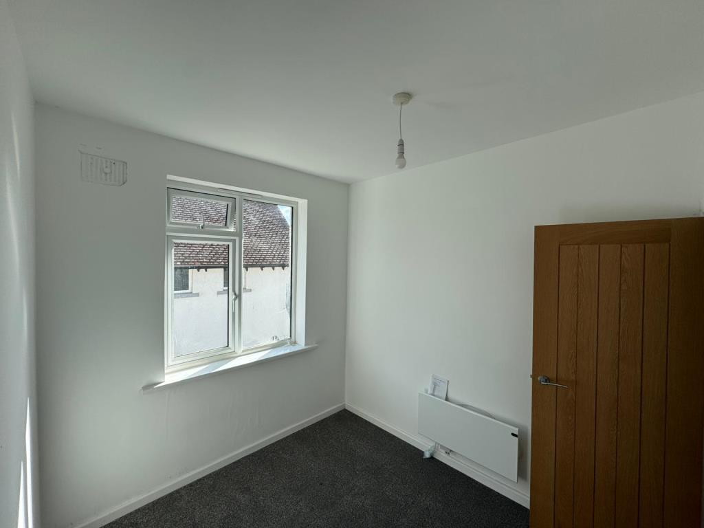Bedroom two with white walls and grey carpet