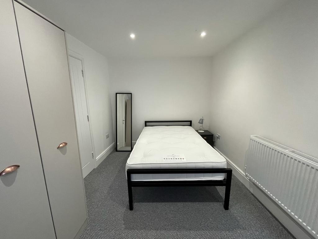 A bright and spacious double bedroom featuring ...