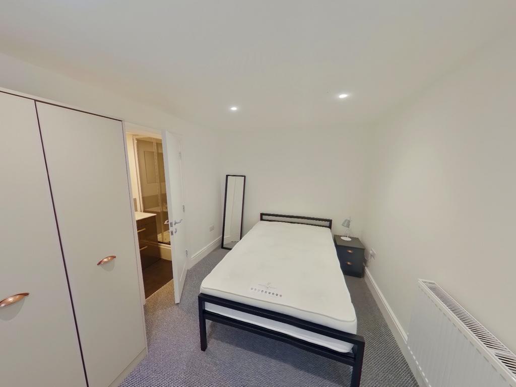 A spacious and bright double bedroom with moder...