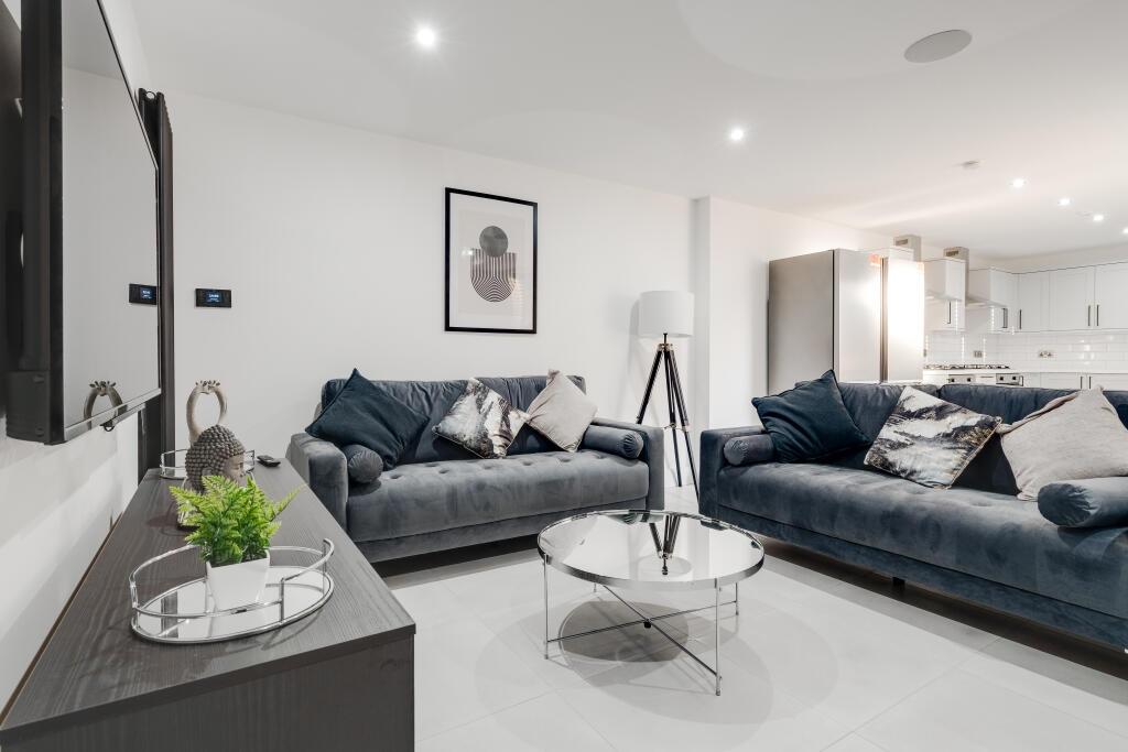 A modern, spacious living room featuring two la...