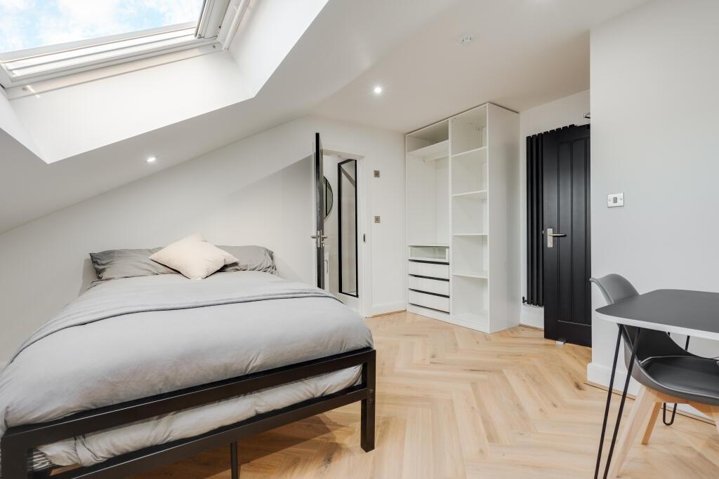 Bright and airy bedroom featuring a large bed, ...