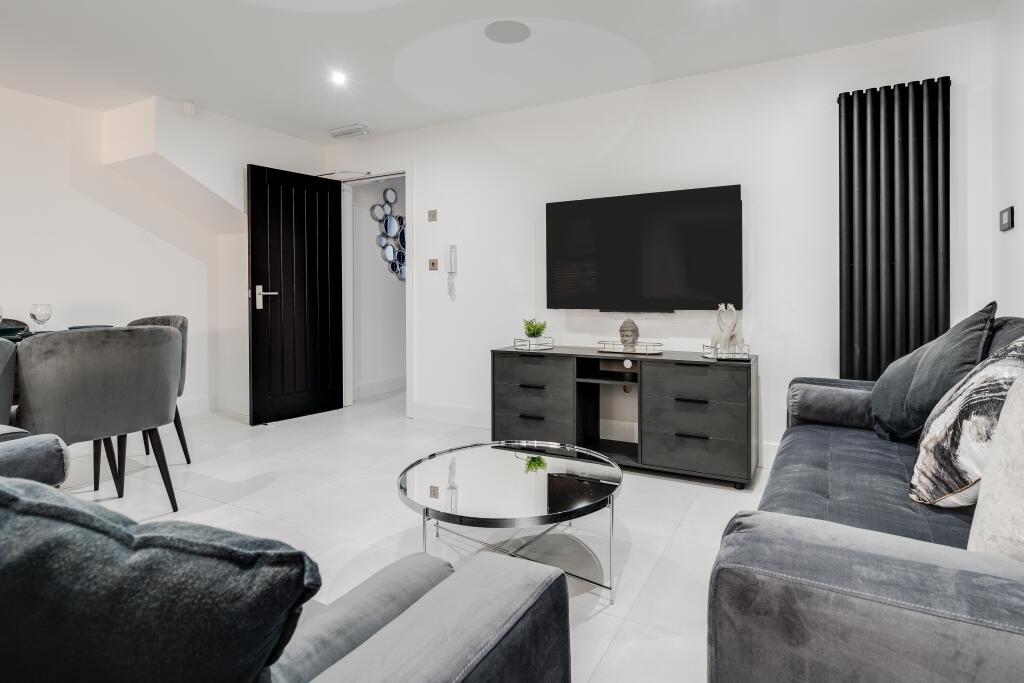 A modern, well-maintained living room featuring...