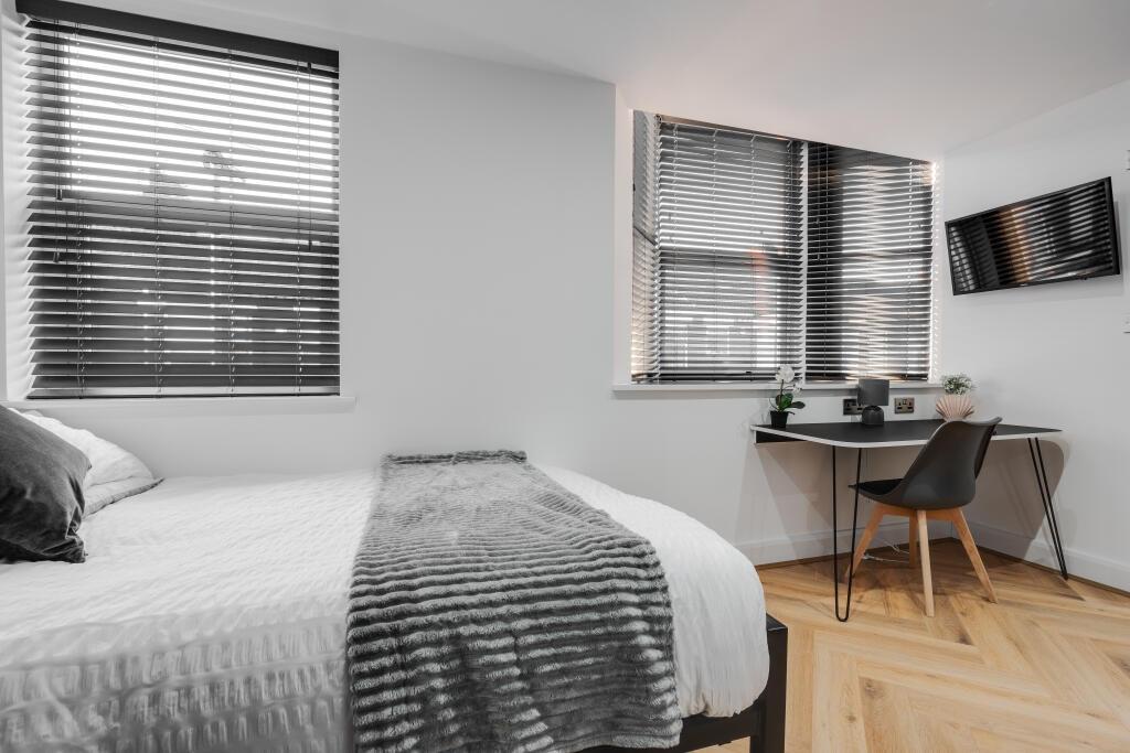 A well-maintained bedroom featuring a comfortab...